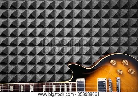 Top View Of Electric Guitar On Acoustic Foam Panel Background