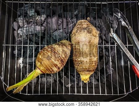 Two Taro Being Grilled On The Stove