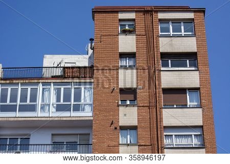 Building Facade Detail With Windows, Blue Sky And Sunligt.