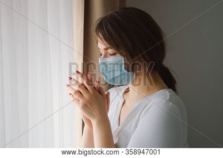 Coronavirus Covid-19. Woman Praying To God Requesting That The Coronavirus Covid 19 Not Spread Beyon