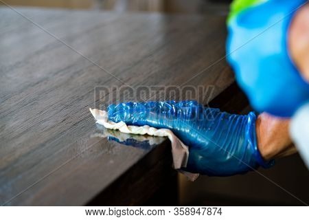 Wearing Protective Gloves And Wiping Down Surfaces And Cleaning During Covid-19 Pandemic