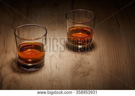 A Glass Of Whiskey On A Wooden Table, Selective Focus.