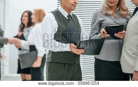 Close Up. Group Of Experienced Employees Standing In Bank Office.