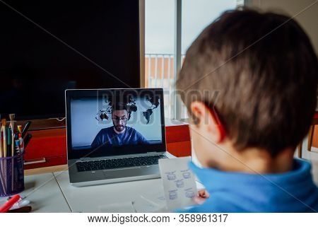 Boy Studying Homework During His Online Lesson At Home