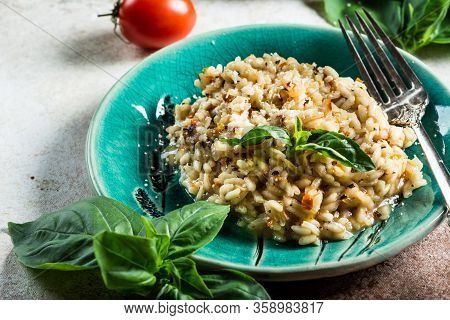 Risotto With Tomatoes On A Green Plate With Basil. Italian Food. Vegan Food Concept. Italian Cuisine