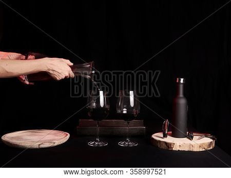 Pouring Two Wine Glasses On Black Background, Glass Pourer Wine Bottle And Wine Utensils