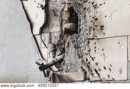 Unexploded Rocket Is Seen In The Wall Of Destroyed House