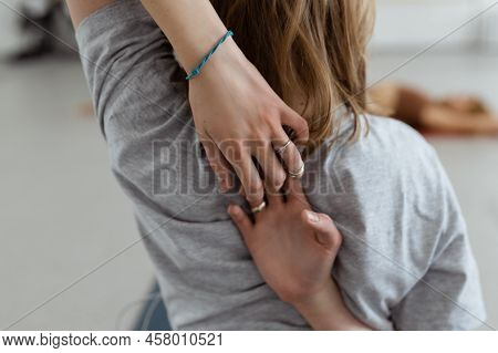 Cropped Close Up Rear View Shot Of Female Yogin Doing Shoulder Stretch Chest Opening Exercises Inter