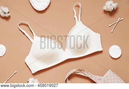 Organic Cotton Concept Flat Lay On The Beige Background With White Bra, Q-tips And Cotton Pads. Top 