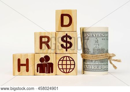 Business Concept. On A White Surface, Dollars And Cubes With Images And The Inscription - Hrd