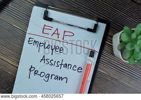 Concept Of Eap - Employee Assistance Program Write On A Paperwork Isolated On Wooden Table.