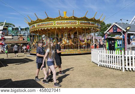 Grantham, Lincolnshire, England- July 9, 2022. Kids Walking In The Wyndham Park At Grantham Fun Fair