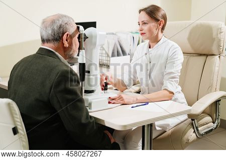 Ophthalmologist Examination Of Elderly Man On Corneo Topographer.modern Clinic