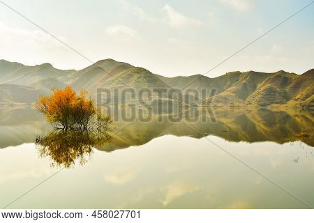 Mravaltskaro Reservoir In Autumn With Tent And White Desert Canyons In Background. Georgia Travel De