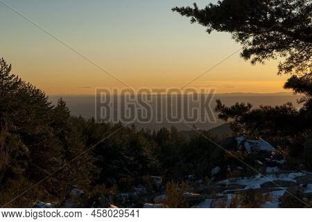 Canchal De La Muela Sunset With Orange Sky And Snow In Spring Extremadura