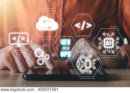 Devops Concept, Man Hand Touching Smartphone With Devops Icon On Vr Screen On Desk, Methodology Deve
