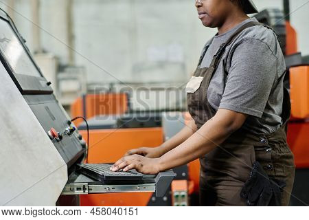 Close-up Of Female Operator In Workwear Choosing Program On Computer Before Starting The Machine