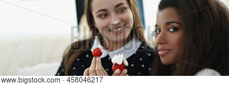 Portrait Of Smiling Pretty Women Eating Tasty Fresh Strawberry Fruit Covered With Whipped Cream. Rom