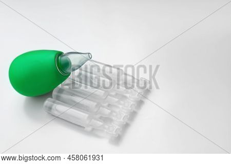 Single Dose Ampoules Of Sterile Isotonic Sea Water Solution And Nasal Aspirator On White Background.