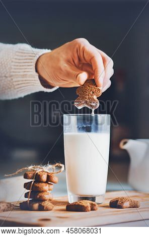 There Is A Glass Of Milk On The Kitchen Table And Oatmeal Cookies Are Lying, And A Man Is Going To D