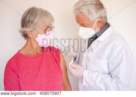 Doctor Giving Injection To Senior Caucasian Woman, Female Receiving Booster Of Covid 19 Vaccine, Peo