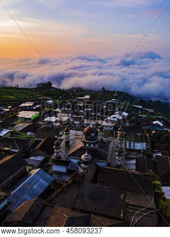 Village With View Sea Of Clouds In The Morning With Orange Sky On The Slope Of Sumbing Mountain