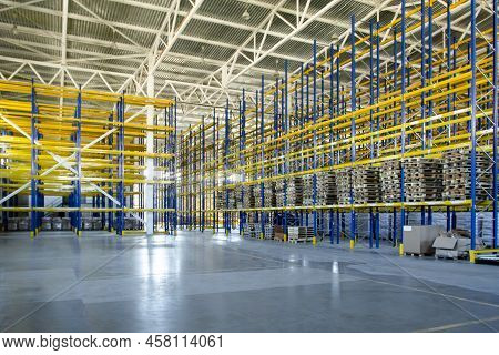 Interior Of A Modern Warehouse Storage Of Retail Shop With Pallet Truck Near Shelves