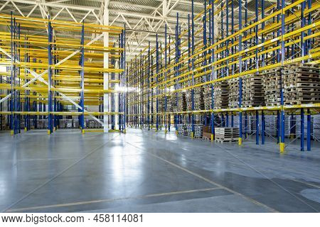 Interior Of A Modern Warehouse Storage Of Retail Shop With Pallet Truck Near Shelves