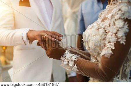 Bride Puts Wedding Ring On Groom\'s Hand