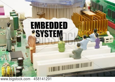 Technology And Computer Concept. On The Motherboard There Are Figures Of People And Torn Paper With 