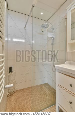 Glass Partition Between Shower Tap And Wall Hung Toilet In Modern Restroom At Home
