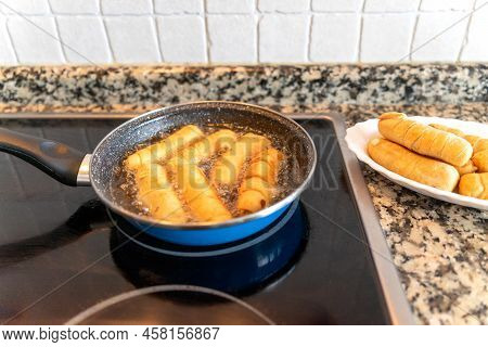 Cooking In Oil Cheese Fingers In A Small Frying Pan. Tequenos Typical Venezuelan Food