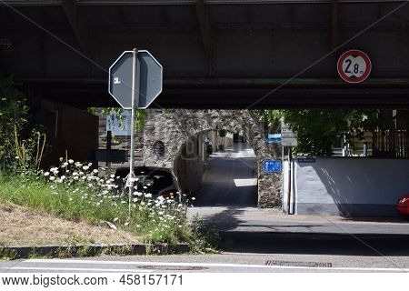 Winningen, Germany - 07 12 2022: Winningen Village Street With Railroad Bridge And A Medieval City G
