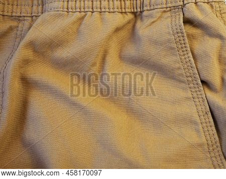 Beige Canvas Fabric Background With Ribbed Texture And Thread Topstitching.