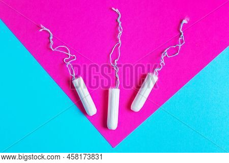 Medical Female Tampon On A Pink Blue Background. Hygienic White Tampon For Women. Cotton Swab. Menst
