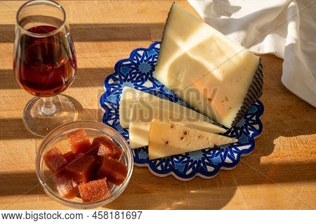 Spanish Hard Manchego, Cow, Sheep And Goat Cheeses Served Outdoor With Membrillo Jam And Glass Of Sh