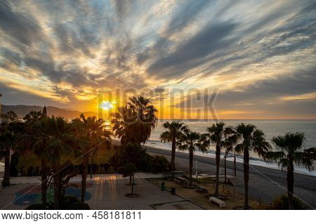 Sunrise Over Sea Water In Torrox Costa, Costa Del Sol, Small Touristic Town Between Malaga And Nerja