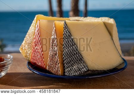 Assortment Of Spanish Hard Cheeses, Curado, Manchego, Goat Cheese Served Outdoor With Membrillo Jam
