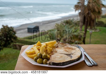 Seafood Dish Served In Beach Cafe With Sea View, Grilled Steak From Swordfish Or Spada Served With F