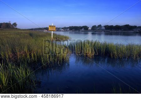 Warning Sign Along The Shore Of The Inter-coastal Waterway At  Holden Beach, North Carolina During T