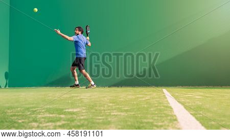 Monitor Practicing Paddle Sport On The Outdoor Court. Man Teaching Padel Class