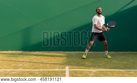 A Caucasian Padel Player Jump To The Ball, Good Looking For Posts And Poster.