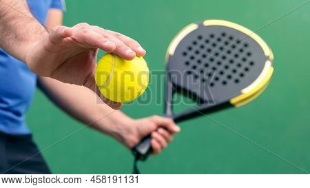 Professional Monitor Of Padel Holding Black Racket On Green Court. Game Concept