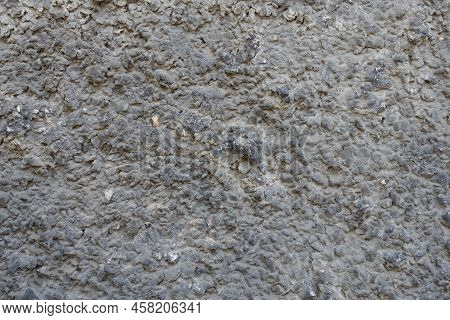 Close View Of Dusty Wall With Coarse Dark Gray Roughcast Finish