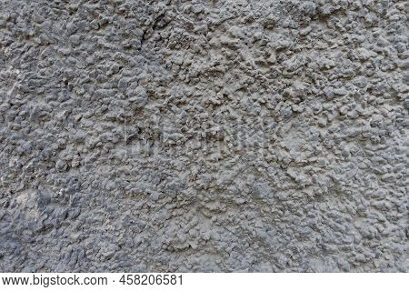Surface Of Dusty Wall With Coarse Dark Gray Roughcast Finish