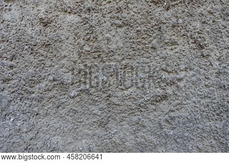 Texture Of Dusty Wall With Coarse Dark Gray Roughcast Finish
