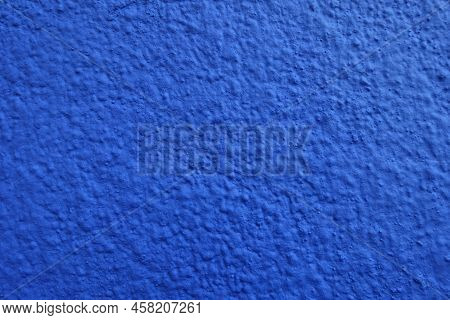 Macro Of Wall With Coarse Vibrant Blue Roughcast Finish