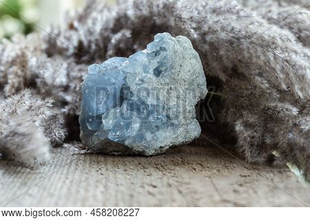 Blue Celestine Or Celestite Stone Mineral Gemstone Close Up On Wooden Background. Natural Healing Ge