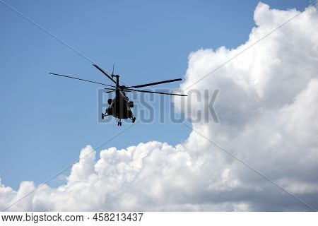 Silhouette Of Military Helicopter Mi-8 (nato Codification: Hip) In Flight On Background Of Blue Sky 