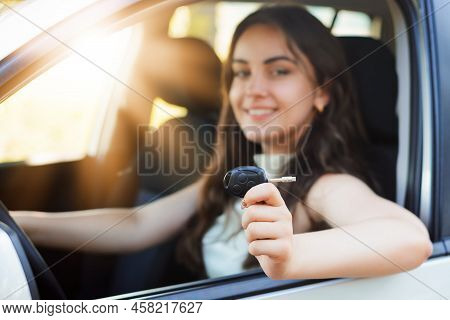 Proud Female Driver With Start Engine Car Key Just After Passing Driving Examination In Driving Scho
